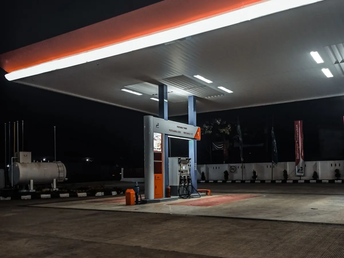 Fuel station forecourt at night